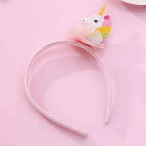 Detail of pink unicorn headband with golden horn, colorful sequins and mesh flower