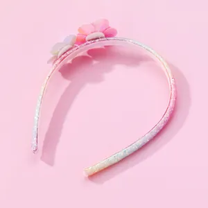 Detail of pink floral headband featuring sparkling sequins and 3D fabric flowers