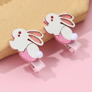 Detail of glitter rabbit hair clips with pink ribbon-wrapped metal duckbill base