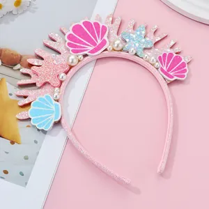 Detailed close-up of pink glitter ocean headpiece with shells and imitation pearls