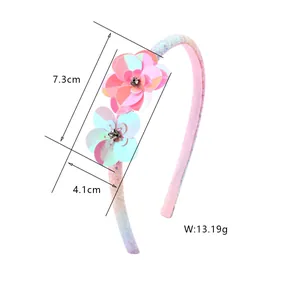 Detail view of pink sequin flower headband with size markings and rhinestone center