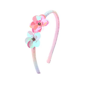 Children's flower headband with shimmering sequins and rhinestone details in pink and blue