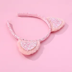 Close-up of pink sequined cat ear headband with soft plush texture and glitter details