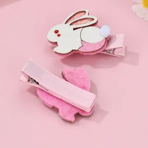 Detail of glitter rabbit hair clips for kids showing both front decor and pink metal clip