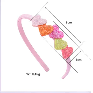 Detail view of heart headband showing glitter accents and dimensions of 9cm width
