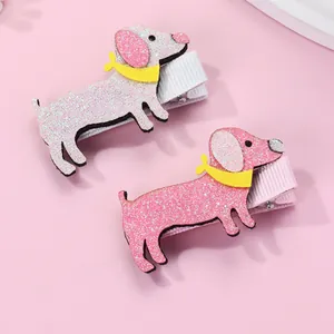 Detail view of pink glitter puppy hair clips with yellow bows for girls