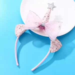 Pink sequin bow headband with silver stars for girls, festive hair accessory on plate