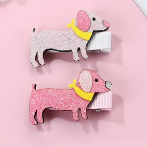 Detail of glittery pink dachshund puppy hair clips with cute yellow bow ties for girls
