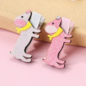 Detail of glitter sausage dog hair clips with yellow scarves and fabric-wrapped bases