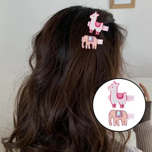 Cute alpaca and pink elephant hair clips for girls set on wavy brown hair