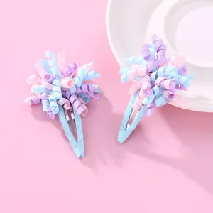 Detail von lockigen Ripsband-Haarspangen für Kinder in Rosa, Blau und Violett