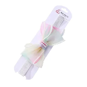 Fascia elastica per bambini con fiocco in tulle sfumato e bordi di perle sintetiche
