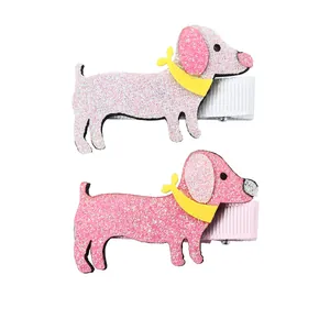 Detail of pink glitter dachshund hair clips with yellow scarf accents for girls