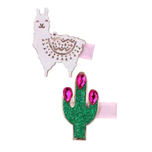 Detail of alpaca and cactus hair clips showing pink ribbon wrapped safety clips