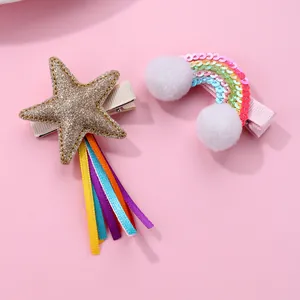 Detail view of kids star and rainbow hair clips with sequins and colorful ribbons