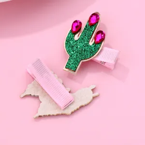 Detail of glitter cactus hair clips with pink ribbon wrapped metal base and felt backing