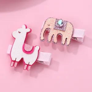 Detail of pink alpaca and elephant hair clips for children with glitter fabric finish