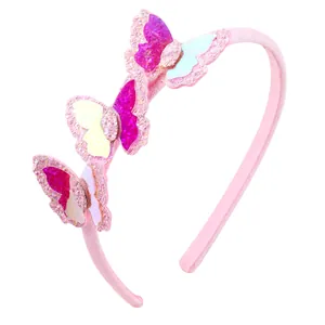 Detail of pink glitter butterflies on a kids headband with soft iridescent sequins