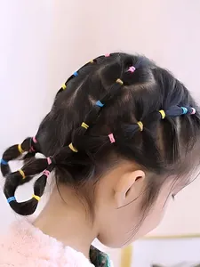 Detail of colorful elastic hair bands used for styling on dark hair in a cute braid
