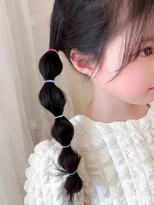 Close-up of colorful elastic hair ties styling a bubble ponytail on a young girl