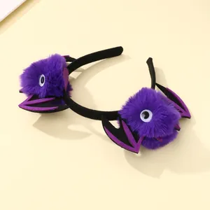 Detail of purple plush bat headband with cartoon eyes for Halloween party decor