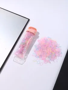 Detailed view of colorful high-elastic hair ties in a transparent storage tube