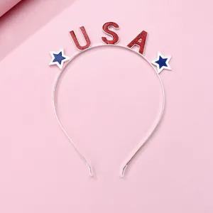 Detail of USA glitter lettering and star motifs on a thin silver metal headband for kids