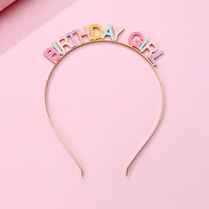 Detail of golden Birthday Girl headband with colorful pastel drip oil enamel letters