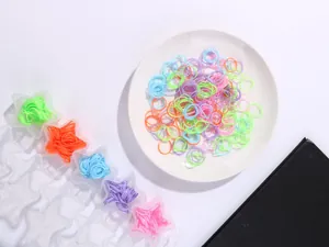 Close-up of colorful elastic hair bands stored in star-shaped transparent containers
