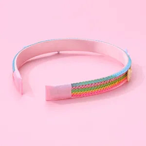 Detail of colorful rainbow sequin kids headband with soft pink satin fabric padding