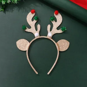 Detail of Christmas reindeer headband with gold sequins and colorful pom-poms