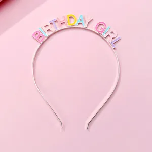 Detail of colorful enamel Birthday Girl letters on a thin metal headband for kids party