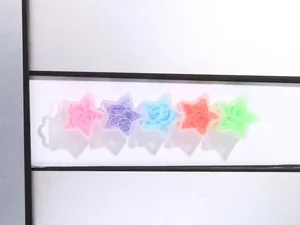 Star-shaped five-compartment storage box with colorful kids' elastic hair ties inside