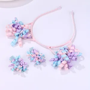 Detailed set of pink floral ribbon headband and matching hair clips for kids on white