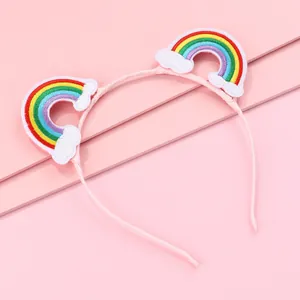Detailed embroidery of rainbow and clouds on a pink non-slip headband for girls
