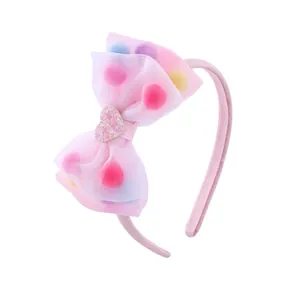 Pink kids headband with organza bow, colorful plush balls and glitter heart detail