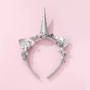 Close-up of silver unicorn horn headband with glitter ears and sequin star details