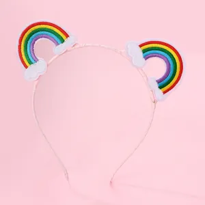 Detail of pink headband with rainbow and cloud embroidery for girls' hair styling