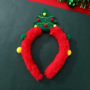 Detailed view of a plush Christmas tree headband with red velvet and colorful pom-poms