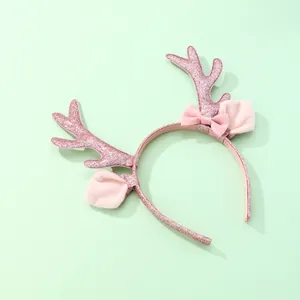 Detalle de diadema de reno rosa con lentejuelas, orejas de peluche y un lazo
