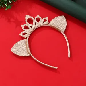 Close-up of golden glitter headband with crown and cat ears for festive parties