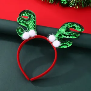 Weihnachts-Rentier-Haarreif mit grünen Pailletten und weißen Plüschbällen auf Rot