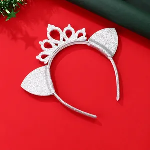 Macro shot of silver sequined cat ear headband with a crown on a festive red background