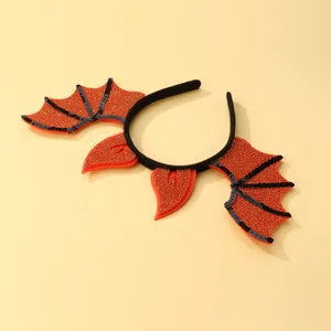 Close-up of Halloween bat headband with orange glitter fabric and black sequins