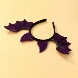 Detail view of Halloween headband featuring purple glitter bat wings and black sequins