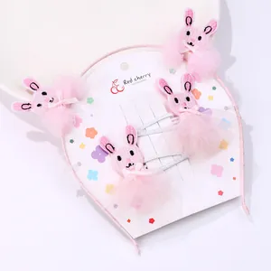 Detail of pink embroidered rabbit hairband and clips set for girls with lace accents