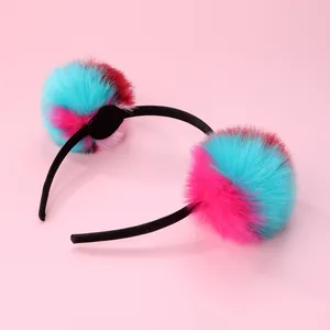 Detailed view of soft colorful faux fur pom pom headband for kids with pink background