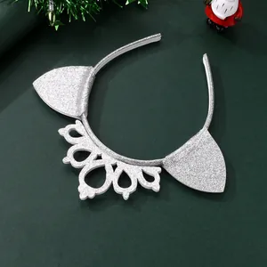 Detail of silver glitter headband with cat ears and crown on festive green background