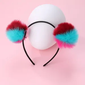 Detail of creative colorful faux fur pom-poms on a slim black non-slip headband