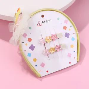 Lot de barrettes étoiles à paillettes roses et jaunes sur carte décorative
